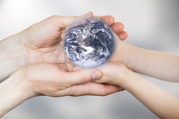 Globe in the hands. Elements of this image furnished by NASA