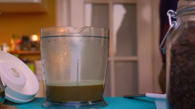 Person making bulletproof coffee with butter and MCT oil