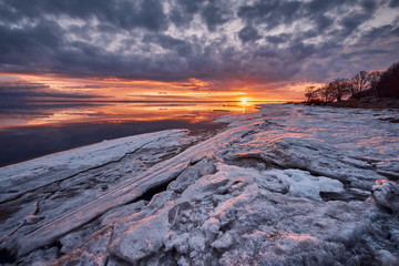 Dramatic winter sunset and icy chaos on the Baltic Sea.
