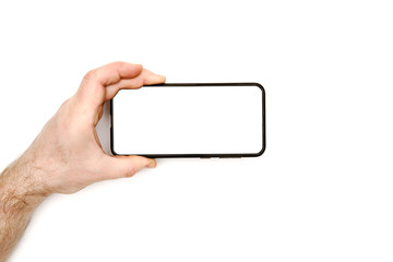 male hand holds a modern black smartphone on a white background. white display. blank for different ideas.