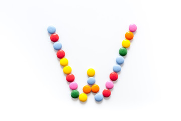 Candies font alphabet. Letter W isolated top view