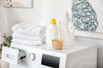 Obraz na płótnie Canvas Detergents and laundry on washing machine
