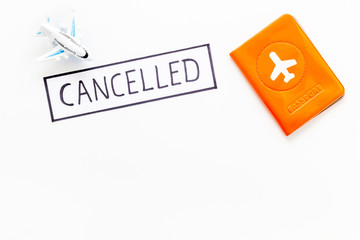 Cancelled flight. Airplane and passport on white background top view copy space