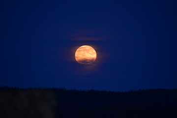 Moon behind clouds in Varmland, Sweden. Very wonderful moon, mysterious.