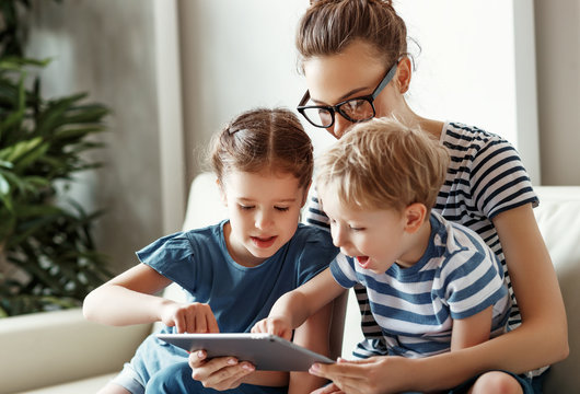 Happy Woman With Kids Using Tablet At Home.