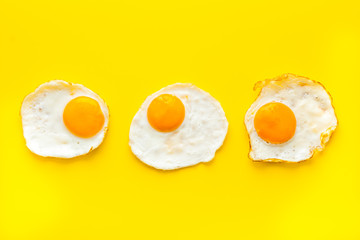 Fried eggs pattern on white table top view