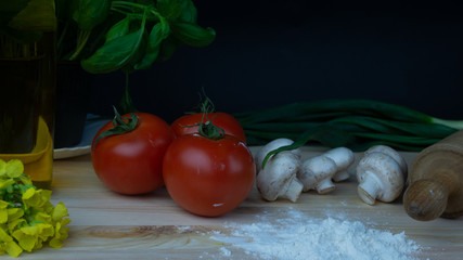 
composition of vegetables, mushrooms, oil, basil, tomatoes