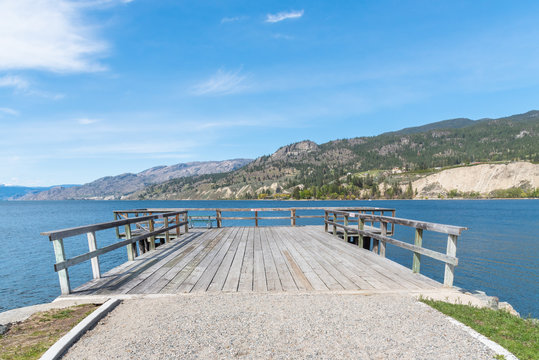 View of wharf, Okanagan Lake, and mountains from the village of Naramata