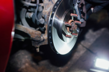 Fototapeta na wymiar installation of ventilated car brake discs in the garage.