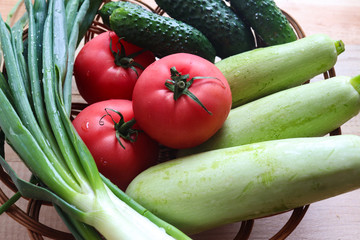 Fresh vegetables. Cucumbers, tomatoes, green onions, zucchini. Healthy eating concept.Flat lay, top view. Vegetarian and organic food. Harvest. Copy space for text.