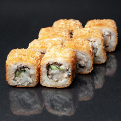 diverse delicious sushi roll set on a black background with reflection, menu