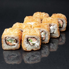 diverse delicious sushi roll set on a black background with reflection, menu