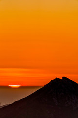 Silhouetted Mountain at Orange Sunset 