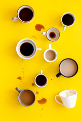 Lots of coffee on yellow background from above