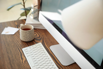 Modern workplace with computer in room