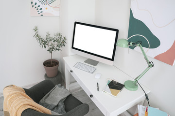 Modern workplace with computer in room