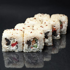 diverse delicious sushi roll set on a black background with reflection, menu