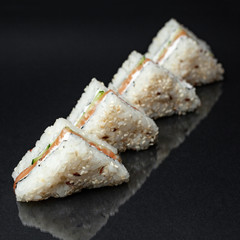 diverse delicious sushi roll set on a black background with reflection, menu
