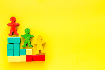 Winners podium. Figures of humans on yellow desk top-down space for text