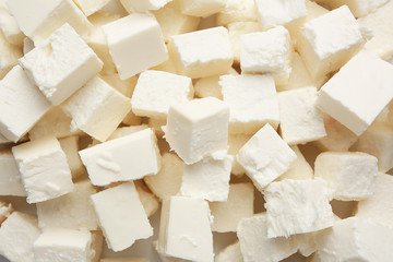 Tasty cut feta cheese as background