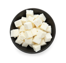 Bowl with tasty cut feta cheese on white background