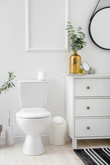 Fototapeta na wymiar Toilet bowl in interior of light modern bathroom