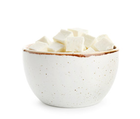 Bowl with tasty cut feta cheese on white background