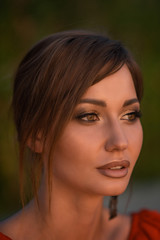 portrait of a brunette girl with golden make-up and red lips.