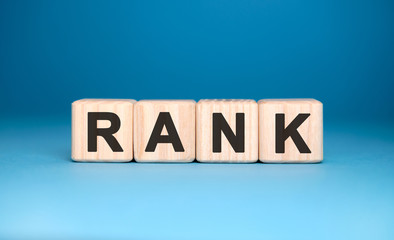 Fototapeta premium RANK website - text concept on wooden cubes with blue background