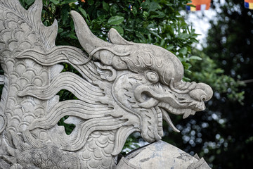 Stone dragon sculpture at the entrance to a Buddhist temple in the city of Danang, Vietnam