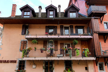 The façades along the Thiou give the old town a definite Venetian atmosphere with their lemon, mustard, pink, salmon and pistachio-coloured roughcast facades, Annecy, France.