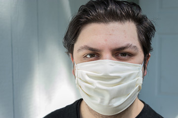 young man with dark hair in face mask for protection