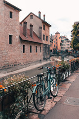 Old bicycle parked near the Palais de l'Ile on the Annecy old town. The Palace, often described as a 