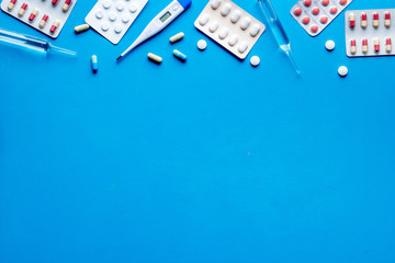 Pharmacy - pills, tablets - flu, cold health care. on blue table top view space for text