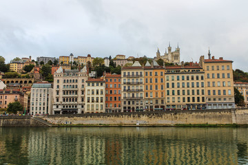 Fototapeta na wymiar Buildings along the Saone River, Quai Fulchiron (quay), in the Old City of Lyon, in the 5th arrondissement (district), and the Fourviere hill, Lyon, France.