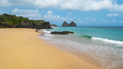 Fernando de Noronha – Brazil. Beautiful tropical beach with rock formations in the background on the island of Fernando de Noronha