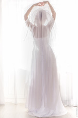 Bride in wedding dress on a white background.