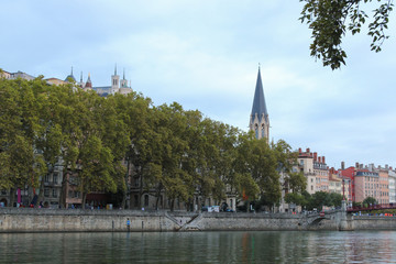 Church of St George with buildings along the Saone River, Quai Fulchiron (quay), in the Old City of Lyon, in the 5th arrondissement (district), Passerelle Saint-Georges bridge, and the Fourviere hill.