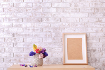 Vase with beautiful hyacinth flowers on table in room