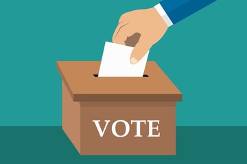 Hand putting paper with vote in the ballot box