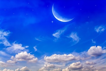 Naklejka na ściany i meble Moon in bright clouds of sunset sun . New moon