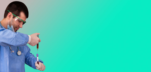 Concept of creating the vaccine against Covid-19. Doctor inserts serum from the syringe into a test tube with space for text on the label