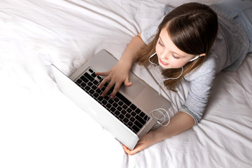 Children who use high-tech opportunities to communicate with each other. Schoolgirl at home. Online education and distance learning for kids. Homeschooling during quarantine.