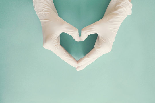 Doctor hands with medical gloves making heart shape, health insurance, donation, charity during covid-19 coronavirus pandemic, saving life, thank you and appreciation to doctor
