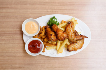 A plate of fried food on the wooden table.