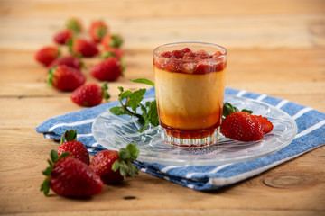 Apricot panacota surrounded by strawberries