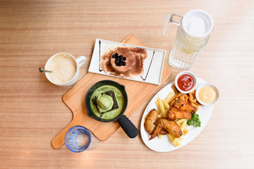 Different food is on the wooden table.