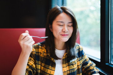 Young Asian woman enjoying delicious food.