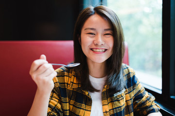 Young Asian woman enjoying delicious food.