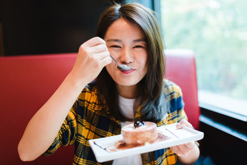 Young Asian woman enjoying delicious food.